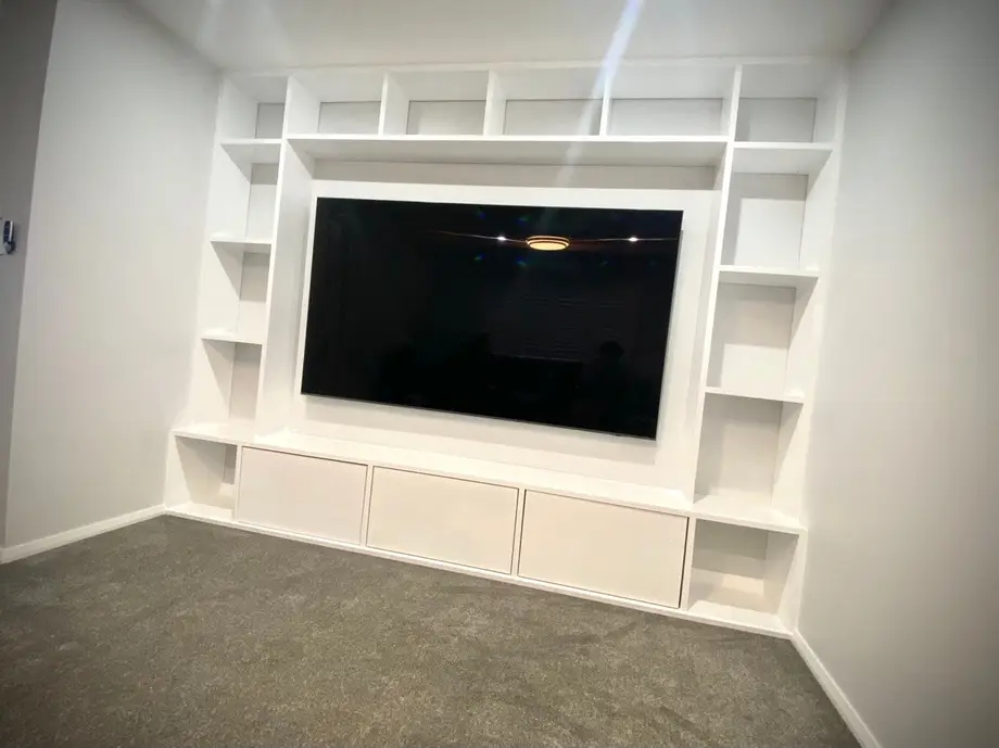 Custom built-in entertainment unit with shelving and cabinets, built by Trusted
